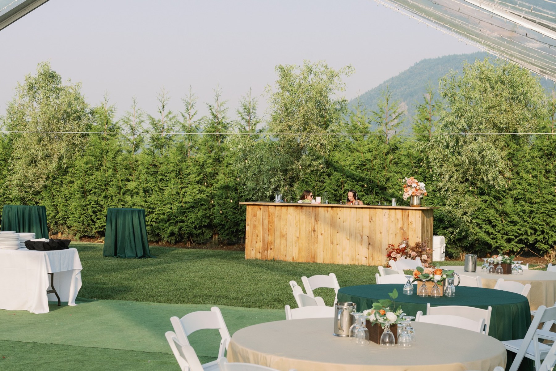 Outdoor bar and seating with the farm’s mountain backdrop